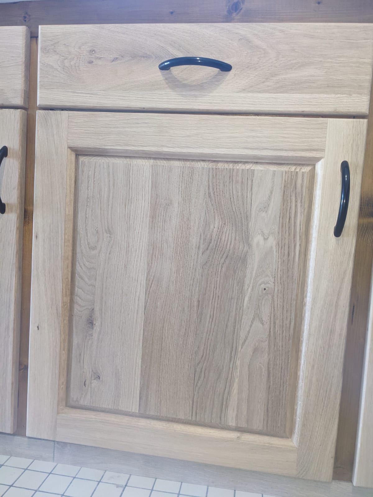 Détail d'une façade de meuble en bois avec poignée noire